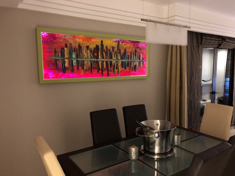 A large glass wall art work with back lighting installed in Spain