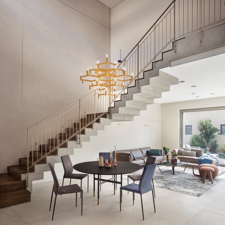 What a chandelier: a modern two-family home with a geometric design